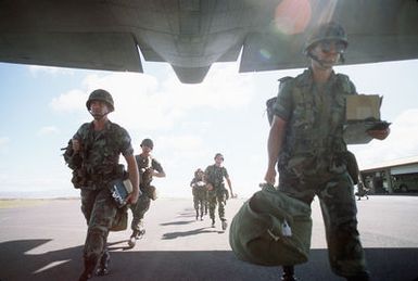 Members of the 29th Brigade, 25th Infantry Division, board a C-130B Hercules aircraft of the 757th Tactical Airlift Squadron, 910th Tactical Airlift Group, Air Force Reserve, during a joint airborne/air transportability training exercise