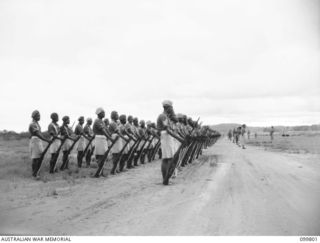 VUNAKANAU, NEW BRITAIN, 1946-02-12. MEMBERS OF THE PACIFIC ISLAND REGIMENT PARADING ON THE LOCAL AIRSTRIP. UNTIL THE WAR ENDED COMPANIES AND PLATOONS SERVED IN MANY DIFFERENT AREAS. IT IS THE FIRST ..