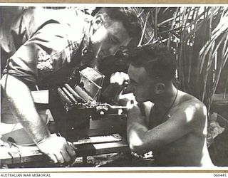 FINSCHHAFEN AREA, NEW GUINEA. 1943-11-07. VX40970 BOMBARDIER C. W. MERTON OF COBRAM, VIC, (LEFT) AND VX14693 BOMBARDIER F. E. CHATFIELD OF BRIGHTON, VIC, (RIGHT), BOTH OF HEADQUARTERS, ROYAL ..