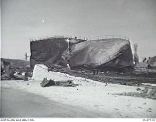 NAURU. 1940-12. WRECKAGE OF THE OIL FUEL TANKS AFTER THE BOMBARDMENT BY THE GERMAN AUXILIARY CRUISER KOMET ON 1940-12-27. (NAVAL HISTORICAL COLLECTION)