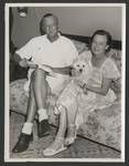 Captain Ross Valder Wheatley and Frances Wheatley, with a dog on her lap, Manus Island, 1949