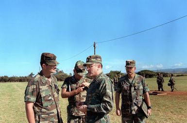 GEN Robert W. Riscassi, second from right, Vice CHIEF of STAFF, U.S. Army, talks with a staff sergeant during his visit to the base. BGEN Craig Hagan, Assistant Division Commander, 25th Infantry Division (Light) stands second from left