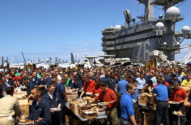 U.S. Navy Sailors enjoy the food nad refreshments during a steel beach picnic on the flight deck of the Nimitz Class Aircraft Carrier USS RONALD REAGAN (CVN 76) at Naval Station Pearl Harbor, Hawaii, on June 28, 2006. REAGAN and Carrier Air Wing 14 are currently on a regularly scheduled deployment. (U.S. Navy photo by Journalist 3rd Class Marc Rockwell-Pate) (Released)