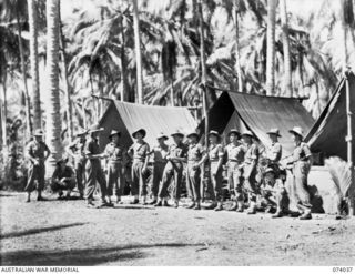 Members of the Administration Staff of Headquarters, A Company, 58/59th Infantry Battalion, holding a conference in their tent lines. Identified, left to right: VX147043 Private (Pte) Kenneth Leo ..