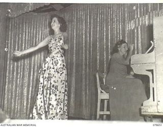 LAE AREA, NEW GUINEA. 1945-01-28. PAULINE GARRICK, SOPRANO (1), ACCOMPANIED BY MISS MAMIE REID, AUSTRALIAN BROADCASTING COMMISSION (PIANIST) (2) AND MEMBERS OF THE DICK BENTLEY CONCERT PARTY ..