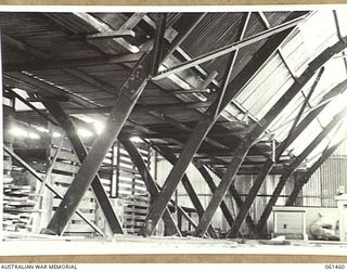 PORT MORESBY, NEW GUINEA. 1943-12-06. PHOTOGRAPH SHOWING THE METHOD USED TO JOIN TWO "ARMCO" HUTS WHICH ARE USED AS BULK STORES BY NO. 2 SUB DEPOT, 10TH AUSTRALIAN ADVANCED ORDNANCE DEPOT