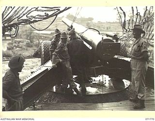 LAE, NEW GUINEA, 1944-03-29. THE 155MM M1918A1 FIELD GUN AT N HEAVY BATTERY, ROYAL AUSTRALIAN ARTILLERY ATTACHED TO HEADQUARTERS LAE BASE SUB-AREA SHOWING THE LAYERS IN POSITION. THE LINE LAYER ..