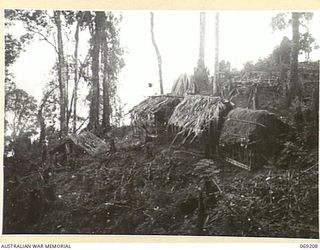 NEW GUINEA. APRIL, 1944. THATCHED HUTS WHICH WERE USED BY AUSTRALIAN TROOPS SITUATED APPROXIMATELY 500 YARDS FROM THE TOP OF SHAGGY RIDGE