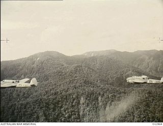 NORTHERN NEW GUINEA. C. 1945-04. TWO BEAUFORT BOMBER AIRCRAFT, CODE KT-Q, KT-B, OF NO. 7 SQUADRON RAAF, IN FLIGHT, CLIMBING INTO THE TORRICELLI RANGES, TO BOMB JAPANESE OCCUPIED POSITIONS AHEAD OF ..