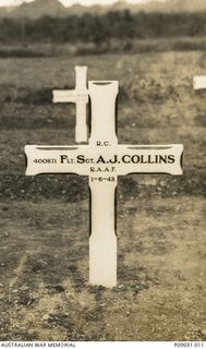 The newly erected cross on the grave of 400871 Flight Sergeant (Flt Sgt) Austin James Collins, air gunner, at Bomana War Cemetery, Papua New Guinea,. Flt Sgt Collins served in Malaya with the RAF ..