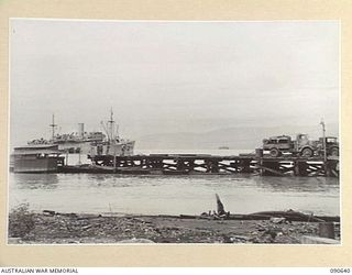 MILFORD HAVEN, LAE, NEW GUINEA. 1945-04-16. CUT AWAY PORTION OF THE COLLAPSED DECK OF A LIBERTY WHARF, WHICH COLLAPSED WITHIN SIX MONTHS OF ERECTION OWING TO THE PILES BEING DAMAGED BY BORERS. ..