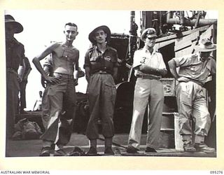THE WHARF, JACQUINOT BAY, NEW BRITAIN, 1945-08-13. A GROUP ON THE DECK OF THE TROOPSHIP VAN OUTHOORN PRIOR TO THE RETURN OF HEADQUARTERS 5 DIVISION PERSONNEL TO AUSTRALIA. THEY ARE SERGEANT L. ..