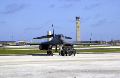 A US Air Force (USAF) ground crew uses an MB-2 aircraft tow tractor to park a USAF B-1B Lancer on the flightline at Andersen Air Force Base (AFB), Guam. The B-1B is here in support of the 7th Air Expeditionary Wing's (AEW) mission