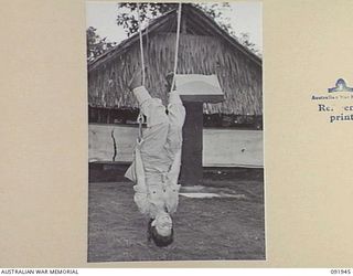 LAE, NEW GUINEA, 1945-05-18. SIGNALWOMAN E. O'CONNOR, AUSTRALIAN WOMEN'S ARMY SERVICE BARRACKS, DOING PHYSICAL EXERCISES AT 112 CONVALESCENT DEPOT DURING A CONDUCTED TOUR OF THE AREA ARRANGED BY ..