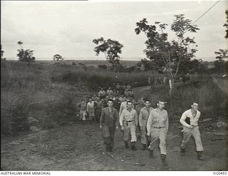 NEW GUINEA. 1944-01-08. RAAF MEN TREKKING ACROSS THE COUNTRY TO A FILM SHOW AT A NEW GUINEA STATION