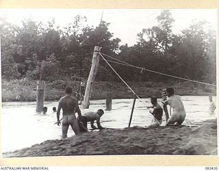 AITAPE AREA, NEW GUINEA, 1944-11. TROOPS OF 22 FIELD COMPANY, ROYAL AUSTRALIAN ENGINEERS, USE WATER PRESSURE TO DRIVE PILES IN THE CONSTRUCTION OF A BRIDGE LOCATED APPROXIMATELY HALF WAY BETWEEN ..