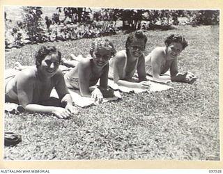 LAE, NEW GUINEA. 1945-10-20. AUSTRALIAN WOMEN'S ARMY SERVICE PERSONNEL OF FIRST ARMY SUNBAKING ON THE LAWNS AT THE AUSTRALIAN NEW GUINEA ADMINISTRATIVE UNIT SWIMMING POOL. THE POOL, WHICH IS FED BY ..