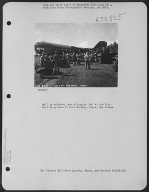 Mail is unloaded from a Douglas C-47 at the 38th Bomb Group base at Port Moresby, Papua, New Guinea. (U.S. Air Force Number 3A32865)