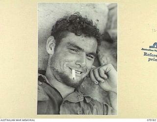 AITAPE AREA, NEW GUINEA. 1945-02-13. NX1337 SERGEANT C.P. HOOPER, 2/2ND INFANTRY BATTALION PROUDLY DISPLAYS HIS 40 DAY OLD BEARD BACK AT CAMP ON THE RETURN OF "JOCK FORCE". "JOCK FORCE" WAS A ..