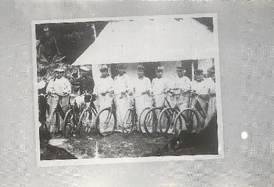 Photo of a group of men with bicycles
