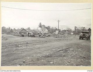 LAE, NEW GUINEA. 1944-09-21. CORPORAL L P L GILLMAN, NEW GUINEA FORCE PROVOST COMPANY ON TRAFFIC DUTY AT CHARING CROSS