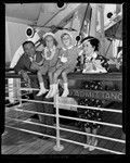 Comedians George Burns and Gracie Allen and children standing at rail of ship in Los Angeles, Calif., 1938