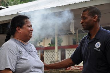 Earthquake ^ Flooding ^ Tsunami - Fagatogo, American Samoa, October 20, 2009 -- FEMA Federal Coordinating Officer Kenneth R. Tingman offers words of comfort to tsunami survivor Rose of Sharon, who lost a loved one and her harbor-side home to the disaster Sept. 29. Richard O'Reilly/FEMA