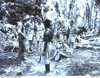 THE SOLOMON ISLANDS, 1945-01-09. AUSTRALIAN AND NEW ZEALAND SERVICEMEN WITH NATIVE LABOURERS AT A COMBINED FORCES TRAINING CAMP. (RNZAF OFFICIAL PHOTOGRAPH.)