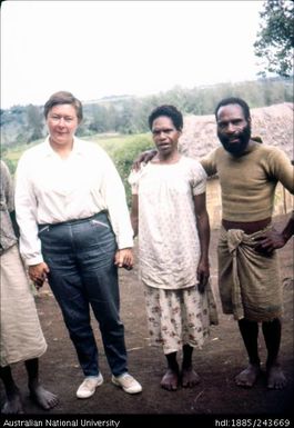 Marie Reay holding the hands of local people