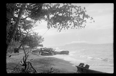 Group of unidentified men sitting in forest area, at RNZAF (Royal New Zealand Air Force) camp, Guadalcanal, Solomon Islands