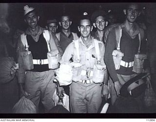 SYDNEY, NSW 1945-08-07. A GROUP OF AUSTRALIAN ARMY PERSONNEL FROM NEW GUINEA, DUE FOR DISCHARGE UNDER THE 5 YEAR PLAN, AT WHARF 12, DARLING HARBOUR. THEY HAVE JUST DISEMBARKED FROM THE SS TAROONA