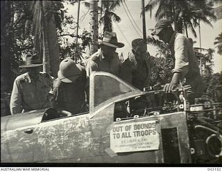 HOLLANDIA, DUTCH NEW GUINEA. C. 1944-06. LIEUTENANT A. G. RUCH, UNITED STATES ARMY AIR FORCE, EXPLAINS THE MOTOR ASSEMBLY OF A CAPTURED JAPANESE OSCAR FIGHTER AIRCRAFT TO THE MINISTER FOR AIR, ..