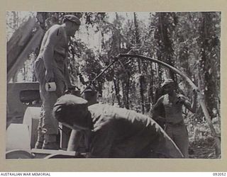 HIRU HIRU, BOUGAINVILLE. 1945-05-16. GUNNERS OF 21 BATTERY, 2/11 FIELD REGIMENT, ROYAL AUSTRALIAN ARMY, USING A MOTOR DRIVEN PUMP TO FILL A WATER CART WITH WATER FROM THE SINDOU RIVER. IDENTIFIED ..