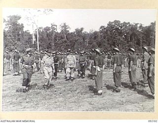 TOROKINA, BOUGAINVILLE. 1945-05-18. LIEUTENANT GENERAL S.G. SAVIGE, GENERAL OFFICER COMMANDING 2 CORPS (4), ACCOMPANIED BY CAPTAIN H.A. HARRIS, OFFICER COMMANDING HEADQUARTERS COMPANY, 25 INFANTRY ..