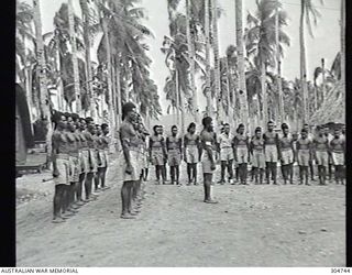 LUNGGA, GUADALCANAL, BRITISH SOLOMON ISLANDS PROTECTORATE. 1943-10-14. NATIVE POLICE SCOUTS AND GUIDES ASSISTING THE COASTWATCHER SERVICE ON PARADE. IN FRONT OF THE PARADE IS SERGEANT YAUWIKA, WHO ..