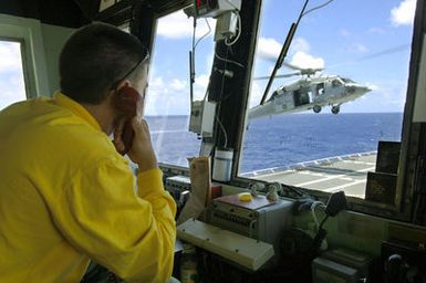 US Navy (USN) Aviatin Batswain's Mate Secnd Class (AB2) Zachary L. Dabney mnitrs the arrival f aUSN MH-60S Sea Hawk helicpter, assigned t Helicpter Sea Cmbat Squadrn 25 (HSC-25), as it delivers supplies t the flight deck abard the USN Military Sealift Cmmand (MSC), Hspital Ship, USNS MERCY (T-AH 19), during a Replenishment at Sea (RAS) evlutin with the USN MSC Mars Class: Cmbat Stres Ship, USNS CONCORD (T- AFS 5). The USNS MERCY is currently underway in the Pacific Ocean, cnducting a scheduled five-mnth deplyment t deliver aid and humanitarian assistance t the Pacific Islands and Sutheast Asia.2006)-- AviatinBatswain's Mate (Handler) 2nd Class Zachary L. Dabney...