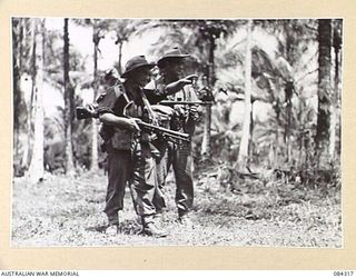 CUTARP PLANTATION, JACQUINOT BAY, NEW BRITAIN. 1944-12-15. PRIVATE PARKINSON, B COY, 19 INFANTRY BATTALION, (1), WHO WAS IN NEW BRITAIN BEFORE THE WAR, SHOWS PTE D A ARMSTRONG, (2), FEATURES IN THE ..