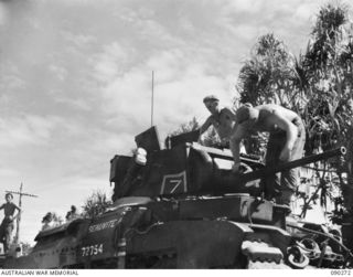 BOUGAINVILLE. 1945-03-30. B SQUADRON, 2/4 ARMOURED REGIMENT PERSONNEL WORKING ON A MATILDA TANK PRIOR TO THE MOVE FORWARD TO TOKO. IDENTIFIED PERSONNEL ARE:- CORPORAL B.A. DENNE (1); TROOPER J.S. ..