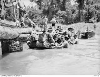 MEVELO RIVER, HENRY REID BAY, NEW BRITAIN. 1945-03-05. TROOPS OF C COMPANY, 14/32ND INFANTRY BATTALION BEING FERRIED ACROSS THE RIVER BY MEANS OF ASSAULT BOATS