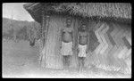 Two young women outside a house