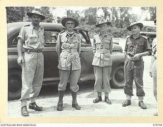 TOROKINA, BOUGAINVILLE, SOLOMON ISLANDS. 1945-03-14. THE ANGLICAN BISHOP OF NEW GUINEA, VX91744 CHAPLAIN P.N.W. STRONG (2), WITH SENIOR OFFICERS AT THE AIRSTRIP AFTER HIS ARRIVAL FROM LAE