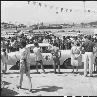 Spectators standing along the sideline during the 1st Safari Calédonien racing event, New Caledonia, 1967, 2 / Michael Terry