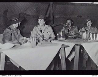 TOROKINA, BOUGAINVILLE, 1945-03-30. LADY WAKEHURST (SECOND FROM LEFT) AND LADY BLAMEY (FAR RIGHT) HAVING REFRESHMENTS IN A RECREATION MESS SOON AFTER THEIR ARRIVAL AT 2/1ST GENERAL HOSPITAL