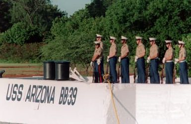 Members of a firing detail from the station's Marine barracks stand at ease as they wait for their cue to fire a 21-gun salute during the observance of the 50th anniversary of the Japanese attack on Pearl Harbor
