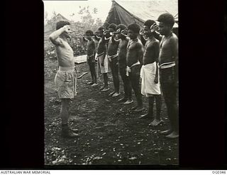 NEW GUINEA. C. 1944-02-17. THE JUNGLE LAUNDRY IS DONE BY NATIVES. AIRCRAFTMAN 1 C. MACBAYNE OF DRUMMOYNE, NSW, IS IN CHARGE. THE NATIVES ARE SALUTING HIM