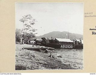 NANTAMBU, OPEN BAY, NEW BRITAIN, 1945-05. MEMBERS OF 37/52 INFANTRY BATTALION, AT THE BARGE POINT ESTABLISHED AT NANTAMBU. FROM THIS POINT SUPPLIES ARE BARGED FORWARD TO WATU POINT AND MAVELO ..