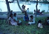 Native women and children sitting by the water, Likiep Atoll, August 20, 1949