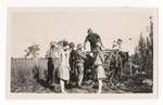 Group of people standing behind a horse lead wooden cart, 1920 to 1929