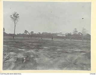 TOROKINA, BOUGAINVILLE ISLAND. 1945-01-06. TROOPS OF THE 42ND LANDING CRAFT COMPANY PLAYING A GAME OF CRICKET DURING A HEAVY RAINSTORM