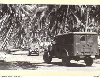 AITAPE, NEW GUINEA. 1944-11-01. VEHICLES TRAVELLING ALONG THE MAIN ROAD TO AITAPE THROUGH HQ 6 DIVISION LINES